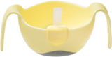 Bol pour enfant de couleur jaune avec 2 poignées sur le coté et un socle gris antidérapant. Le bol est posé sur un fond transparent. Sur le bol il y a une paille en silicone d'accrocher au rebord