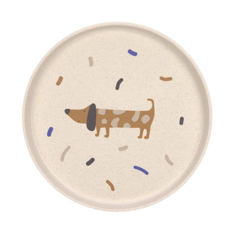 Assiette pour enfant de couleur beige avec une illustration de chien de cotillons colorés. L'assiette est sur un fond blanc
