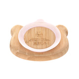 AL1 dos d'une assiette en bambou en forme de souris. L'assiette a une ventouse en silicone de couleur rose. Sur le centre il y a des indication d'utilisation de gravé ainsi que le logo de la marque : Lässig