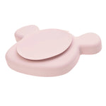 Sur fond blanc, dos d'une assiette en silicone de couleur rose. la forme de l'assiette laisse à penser qu'il s'agit d'une tête de souris. L'assiette est équipée d'une ventouse intégrée à celle co