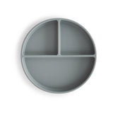 Assiette en silicone compartimentée sur un fond blanc et de couleur grise