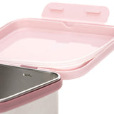 Zoom sur le couvercle d'une boite à gouter en acier et son couvercle en plastique rose. Le couvercle est aquipé d'un joint en silicone transaparant