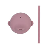Couvercle en silicone de couleur rose avec posé a coté une paille de la même couleur