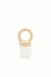 Grignoteuse pour enfant en silicone avec un anneau qui a des formes de boules de couleur beige