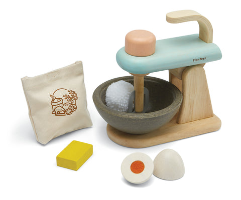 Ensemble de jouet en bois d'imitation pour enfant representant un robot de cuisine à patisser avec à l'intérieur du bol un pompon en laine, a coté du robot est posé un sac à farine, une tablette de beurre et un oeuf ouvert en 2
