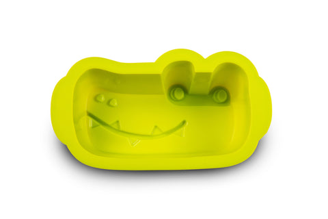 Moule en silicone de couleur vert en forme de tête de crocodile posé sur un fond blanc