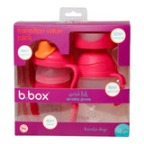 bE Emballage d'un pack de transition pour enfant de la marque B.box, l'emballage est de couleur rose et transparent sur le devant, il contient une tasse d'apprentissage et 4 couvercle different
