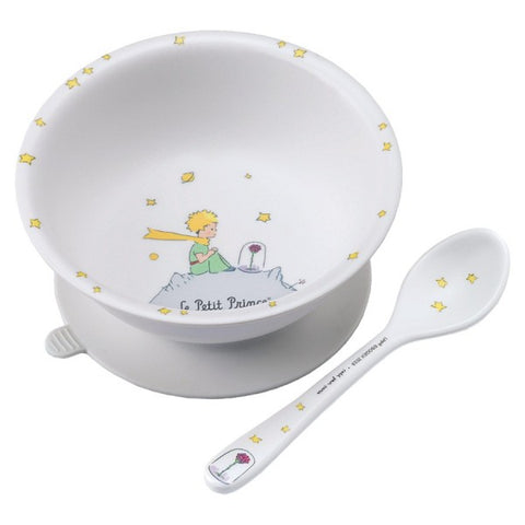 PJP2 photo d'un bol avec sa ventouse et sa petite cuillère. Le bol est blanc avec des illustration à l'effigie du Petit Prince dessus