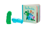 Photo sur fond transparant de 2 brossettes a dents en silicone de couleur verte et bleue avec à coté un petit livre en carton avec comme titre The Bruchies