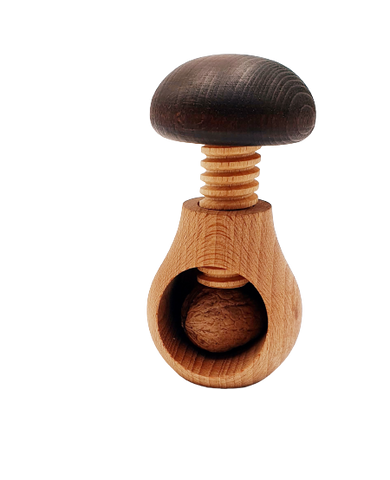 Casse noix en bois en forme de champignon. Une noix est dans l'orrifice dédié, il faut tourner le haut du champignon pour casser la noix 